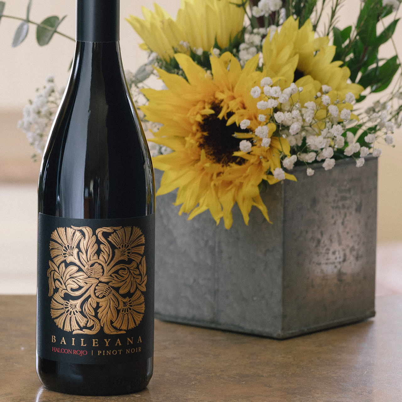 2018 Baileyana Halcon Rojo Pinot Noir with bouquet of flowers